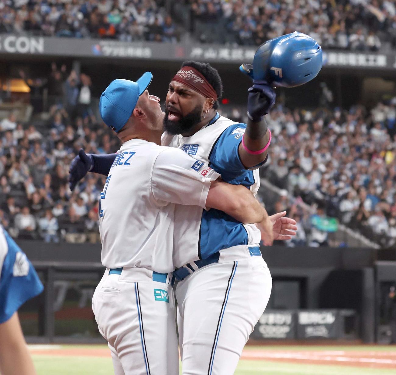 日本ハム対オリックス　8回裏日本ハム2死一、二塁、右前2点適時打を放ったレイエス（右）はマルティネスと抱き合う（撮影・黒川智章）