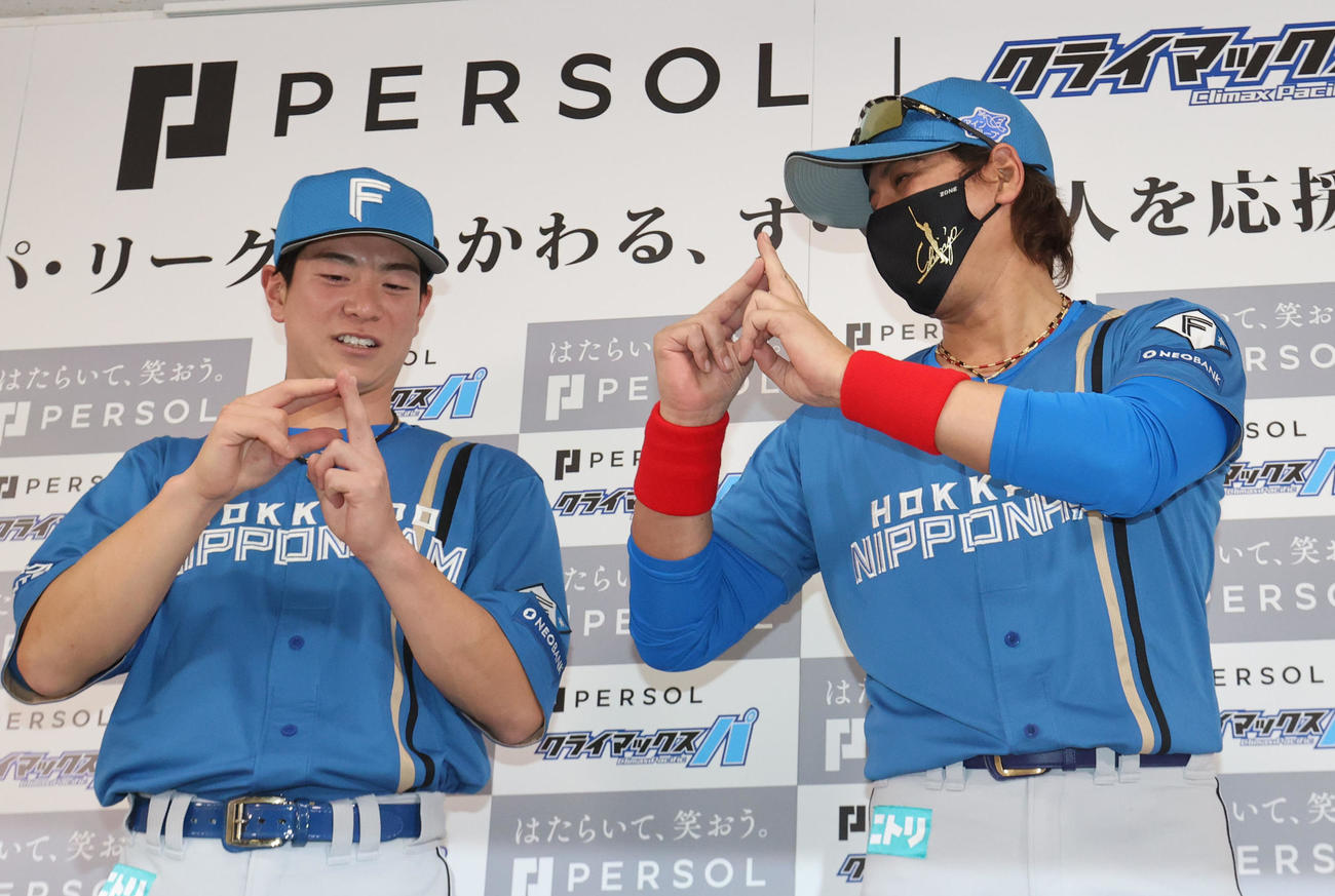 会見終了後のフォトセッションで今季ソフトバンクスローガン「PS！（ピース）」のやり方を松本剛に教える新庄監督（撮影・梅根麻紀）