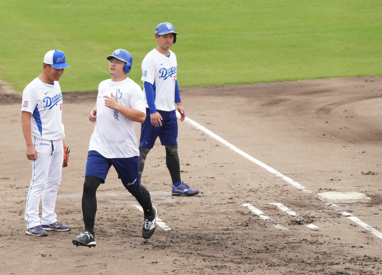 中村外野守備走塁コーチ（左）は大きいサイズのベースを利用し走塁を指導する（撮影・森本幸一）