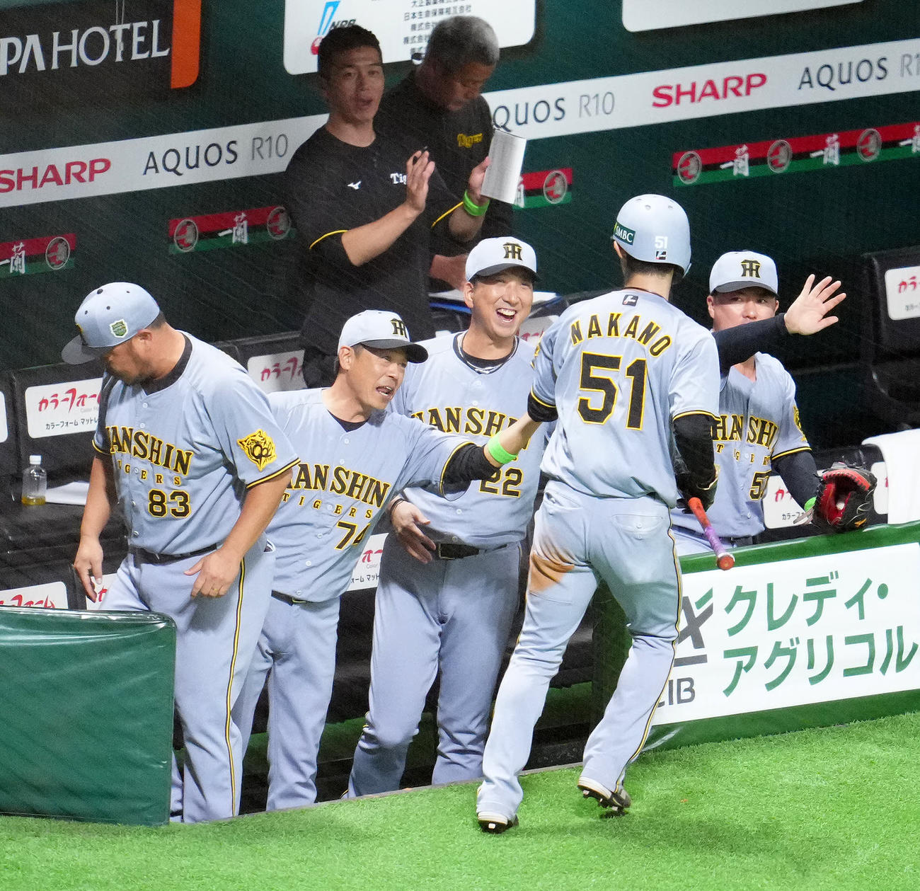 ソフトバンク対阪神　6回表阪神1死三塁、佐藤輝の適時二塁打で生還した中野（左から4人目）を笑顔で迎える藤川監督（同3人目）（撮影・江口和貴）