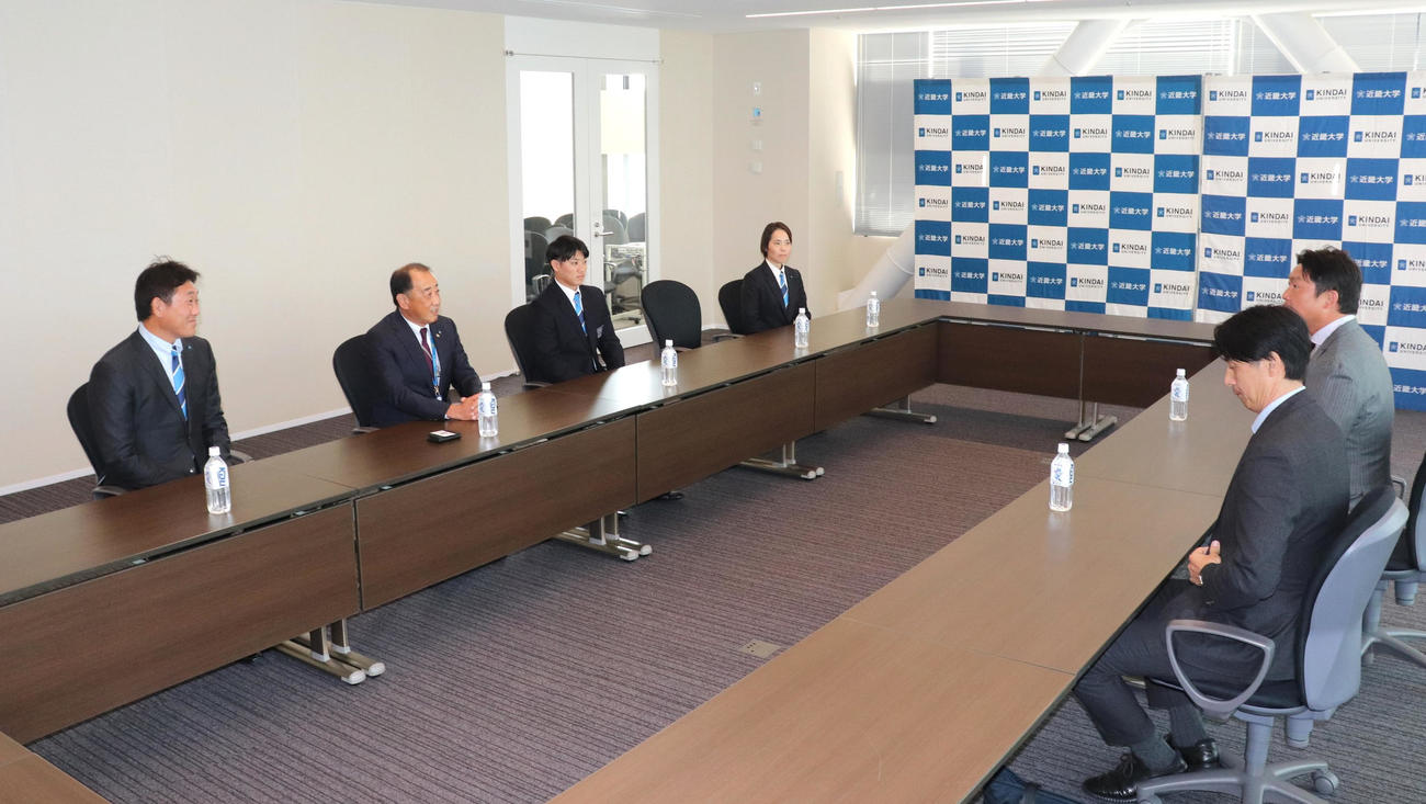 広島・新井監督と鞘師担当スカウトから指名あいさつを受ける同3位の近大・勝田（写真左から3人目）（撮影・中島麗）