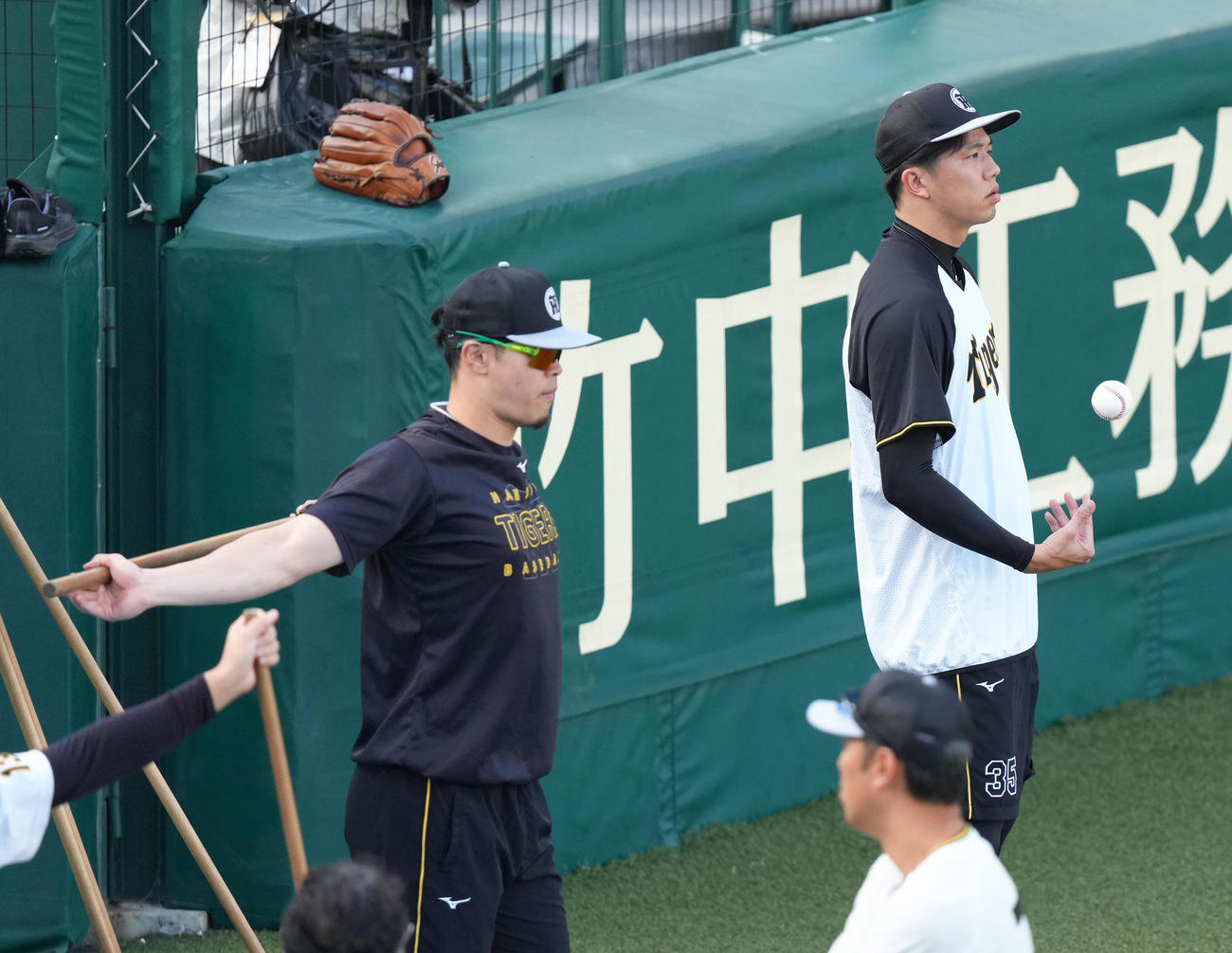 調整する阪神の佐藤輝（左）と才木（撮影・足立雅史）