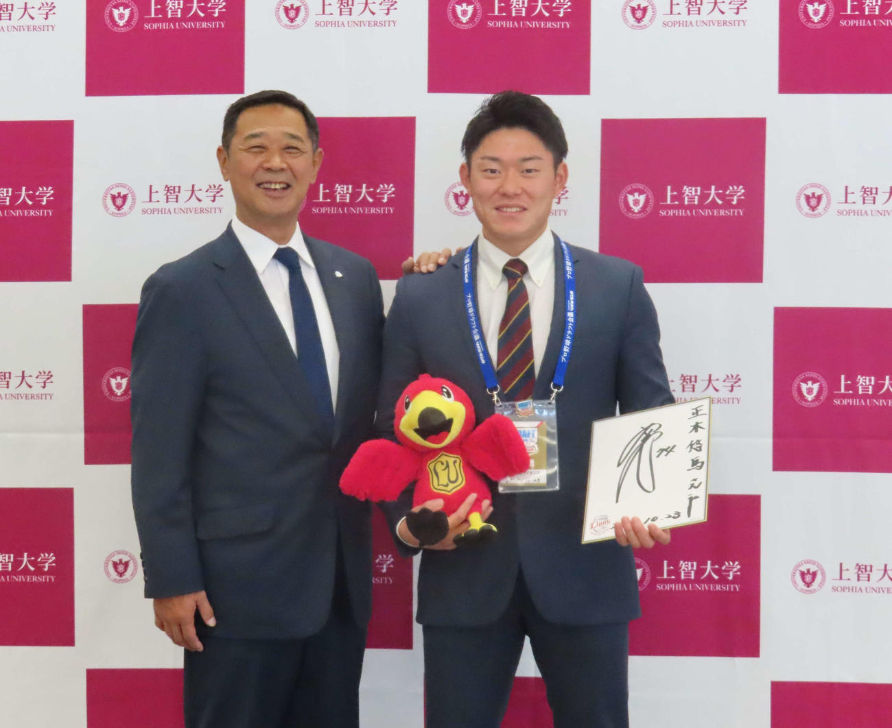 指名あいさつを受けた西武育成6位の上智大・正木（右）と秋元球団副本部長（撮影・山本佳央）