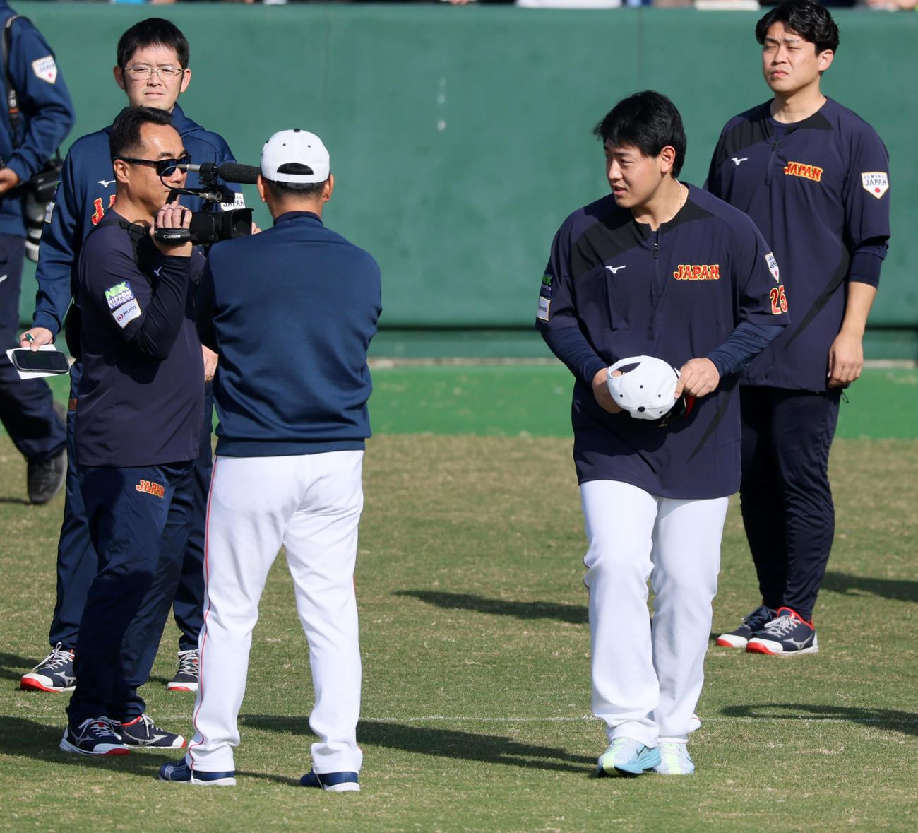 グラウンドへ出て井端監督（左）にあいさつする岡本（撮影・加藤哉）