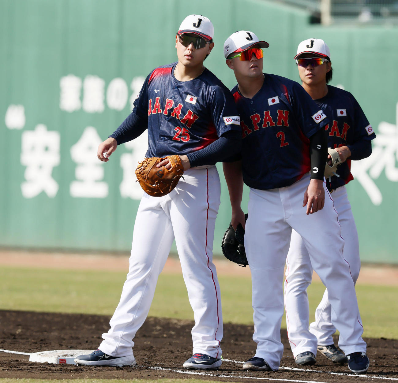 投内連係プレーの練習で牧が装着しているピッチコムからの指示を岡本（左）が耳を近づけて確認（撮影・加藤哉）