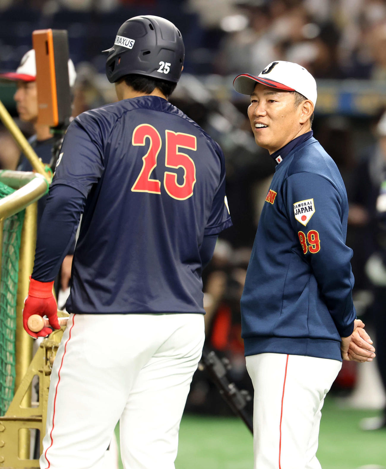 韓国対日本　打撃練習中、井端監督（右）は笑顔で岡本と話す（撮影・浅見桂子）