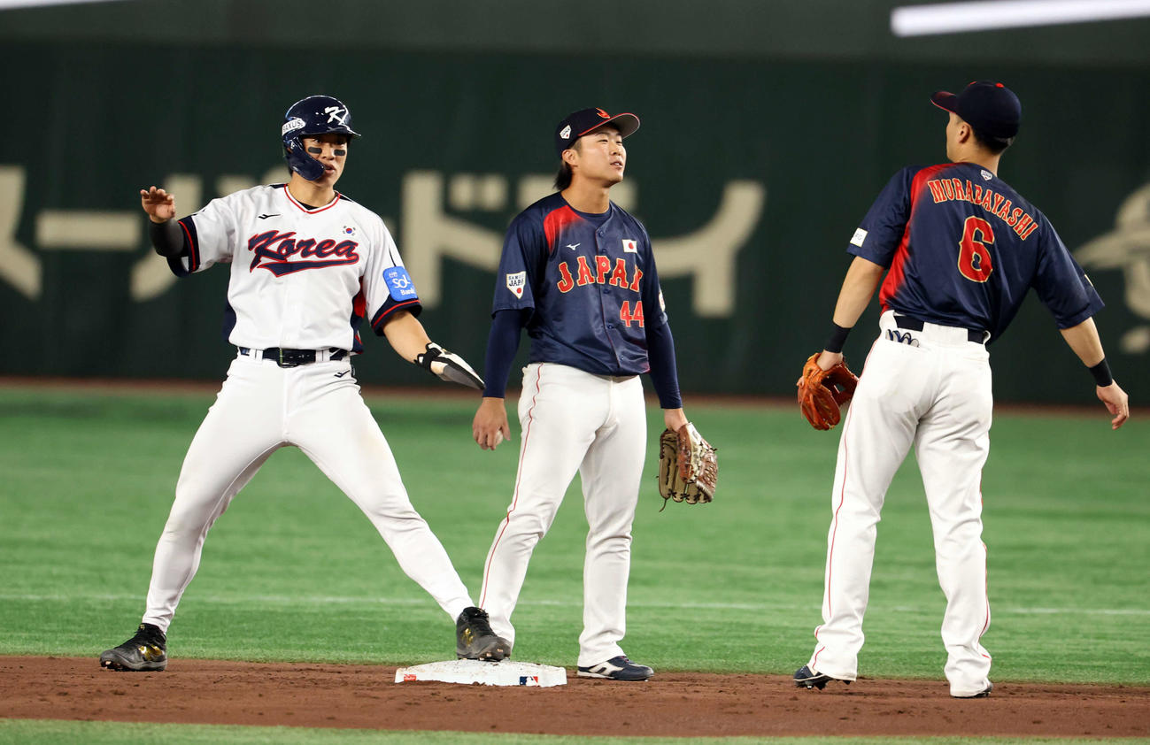 韓国対日本　3回裏韓国1死一、三塁、韓東熙の三振で二塁盗塁を決める宋成文（左）。右は村林、中央は石上（撮影・浅見桂子）