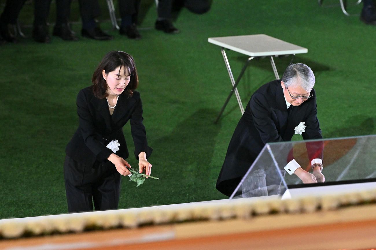 献花する長島三奈さん（左）と巨人山口寿一オーナー（撮影・滝沢徹郎）