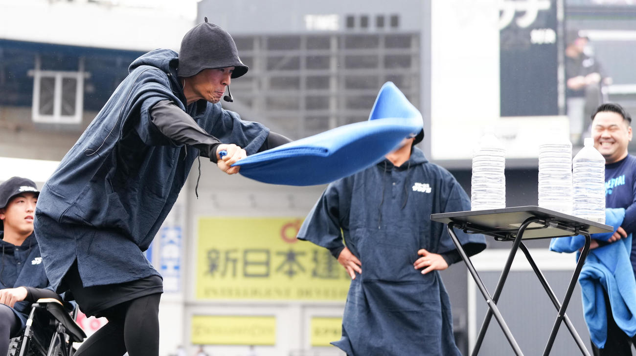 「サウナ対決」でペットボトルを倒すロッテ岡（撮影・鈴木みどり）