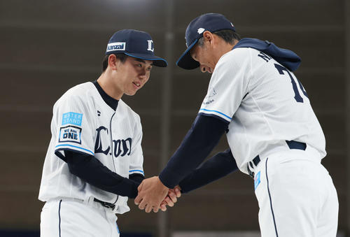 西武ファン感謝イベント「LIONS THANKS FESTA 2025」の新入団選手発表会で西口監督（右）と握手するドラフト1位小島（撮影・宮地輝）