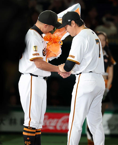 引退セレモニーで、大泣きする巨人阿部監督（左）から花束を贈られる長野（撮影・浅見桂子）
