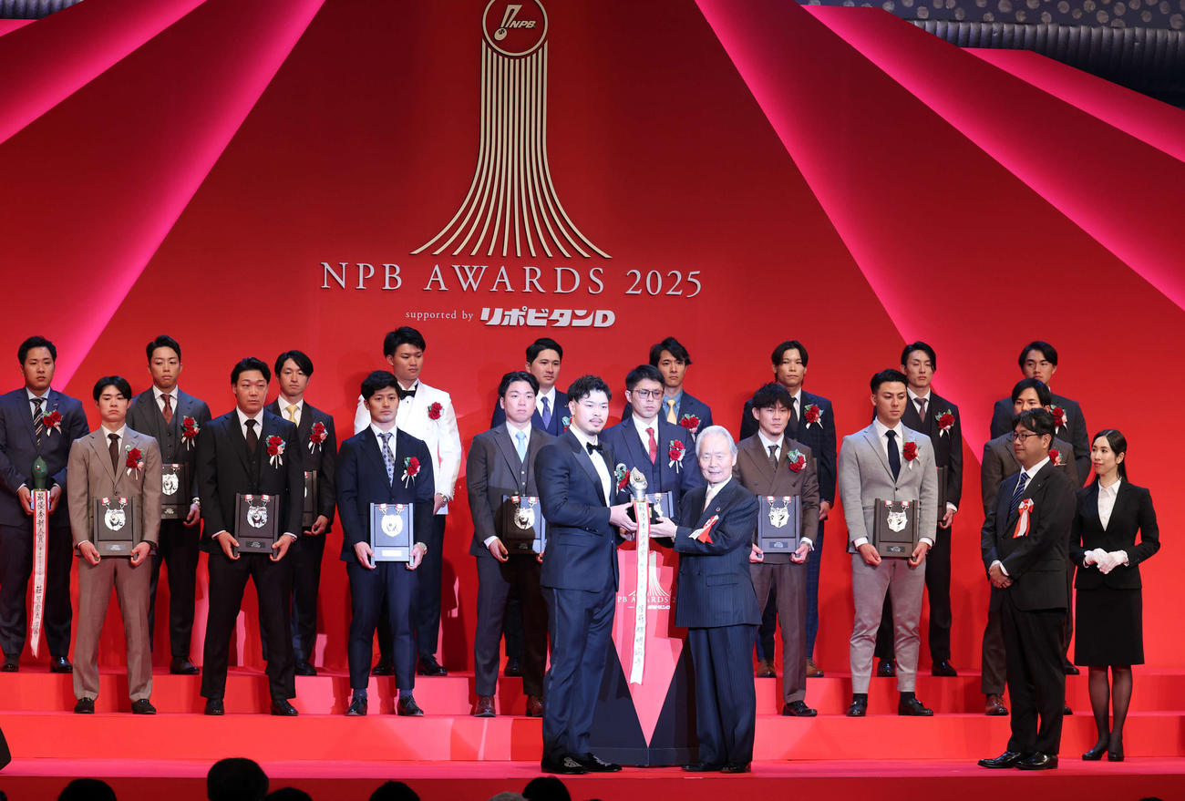 NPB AWARDS 2025　最優秀選手賞を受賞した阪神佐藤輝（左）は榊原コミッショナーからトロフィーを受け取る（撮影・浅見桂子）
