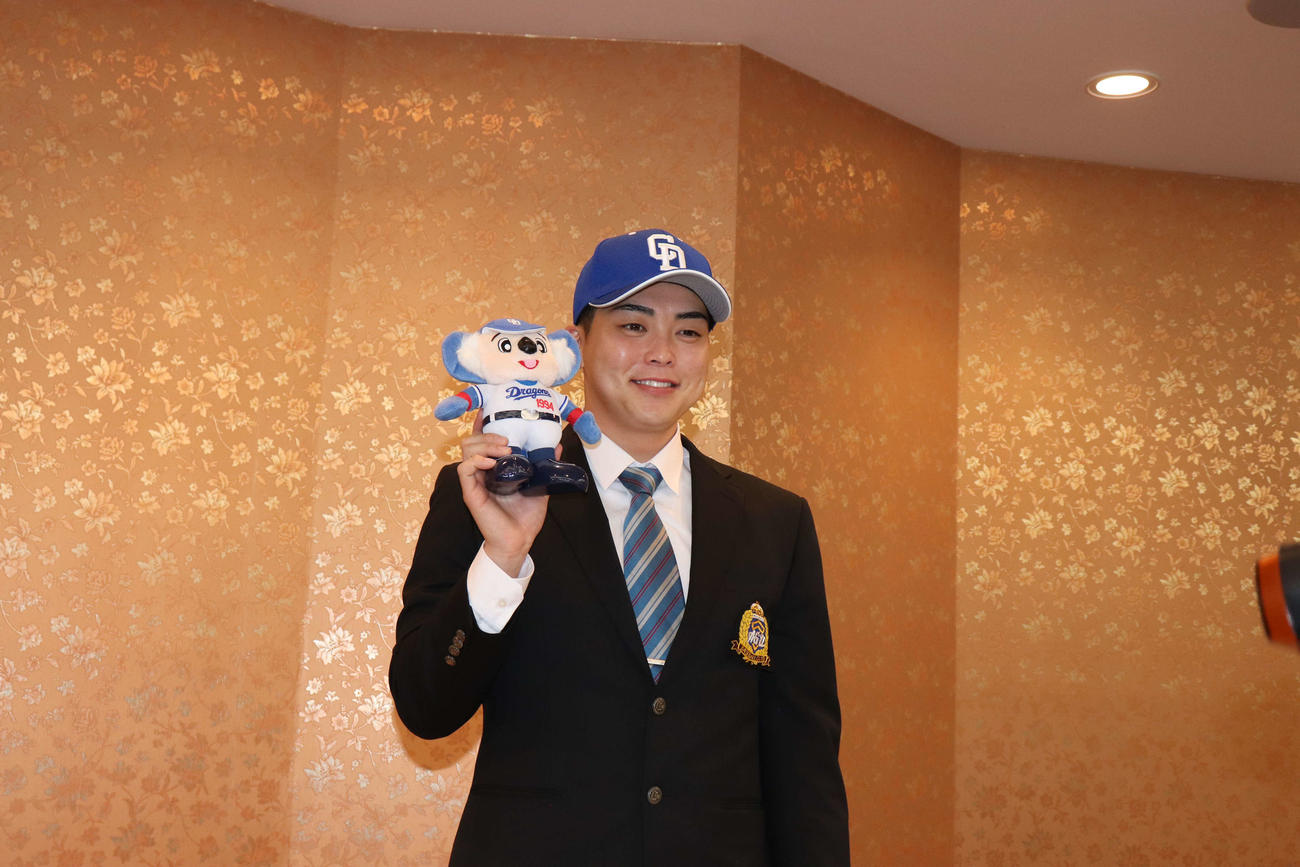横浜市内のホテルで仮契約に臨み笑顔で球団マスコットキャラクターのドアラを手に持つ中日ドラフト1位の青学大・中西