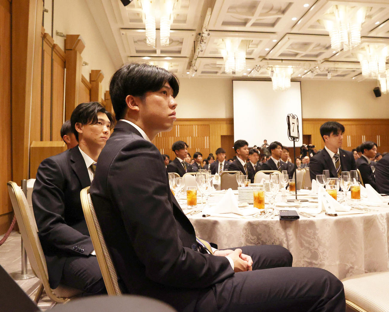 阪神球団納会の席に着く才木（手前）と湯浅（撮影・上山淳一）