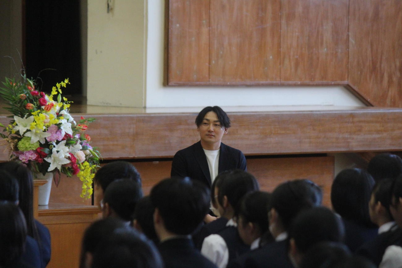 中学生を前に講演する丸