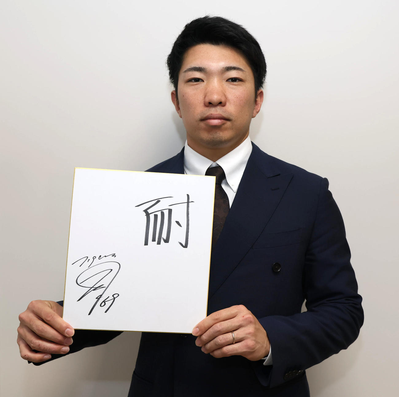 今年の漢字を「耐」と色紙に書いた石井（撮影・加藤哉）