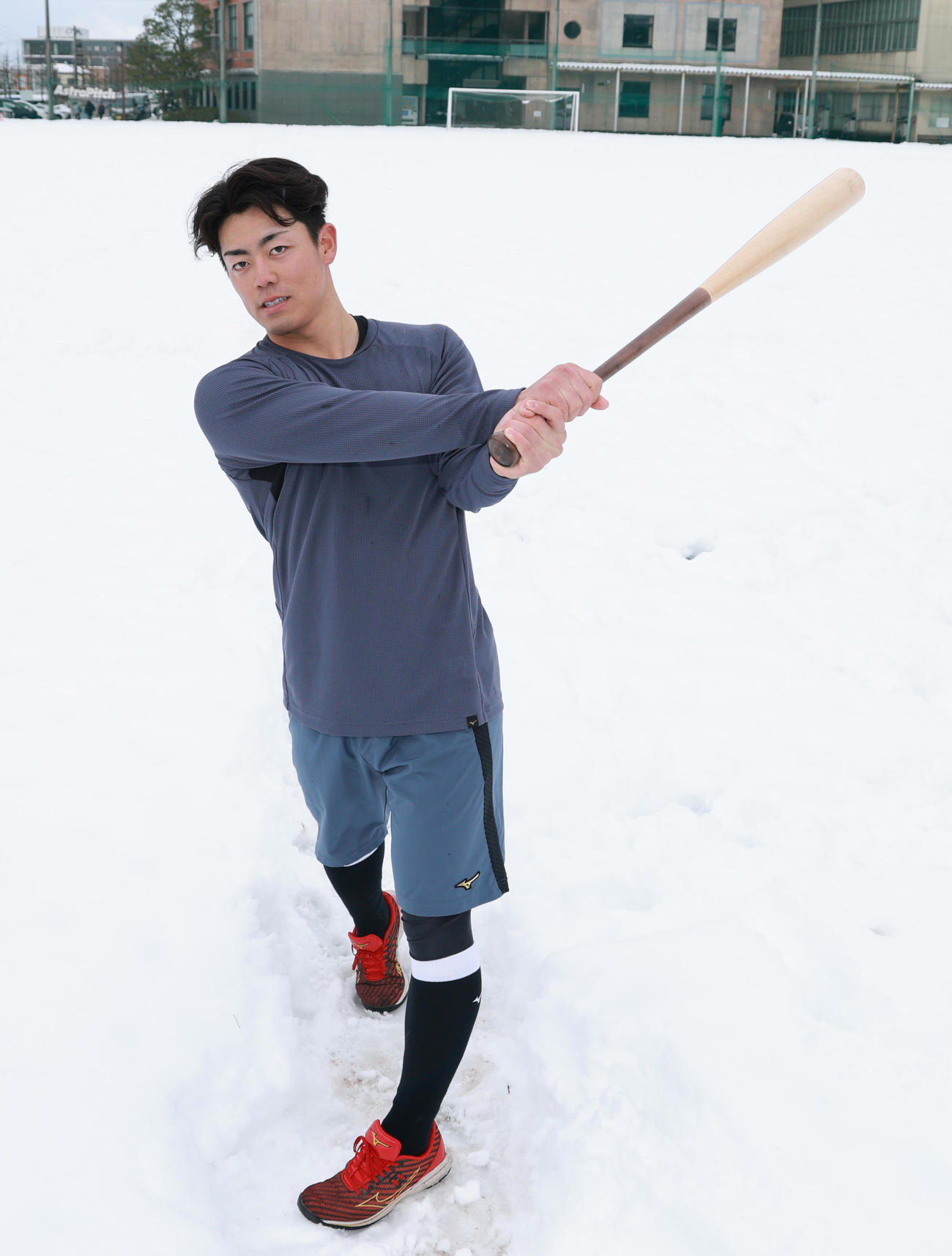 雪の積もったグラウンドで素振りをする阪神ドラフト2位の谷端（撮影・上田博志）