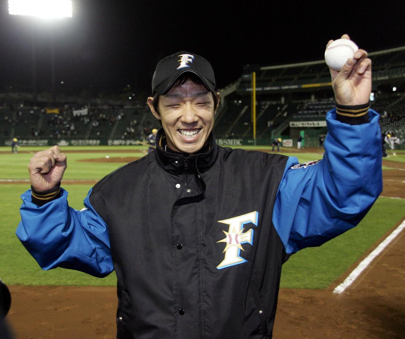 プロ初登板初勝利した八木智哉はウイニングボールを掲げ笑顔を見せる（06年3月31日）