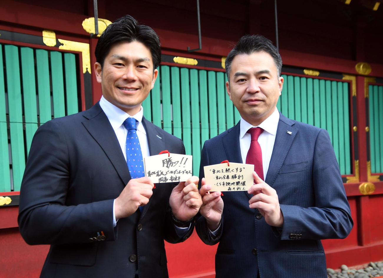 塩釜神社を参拝し、絵馬を手に記念撮影する楽天の岡島アンバサダーと森井球団社長（右）