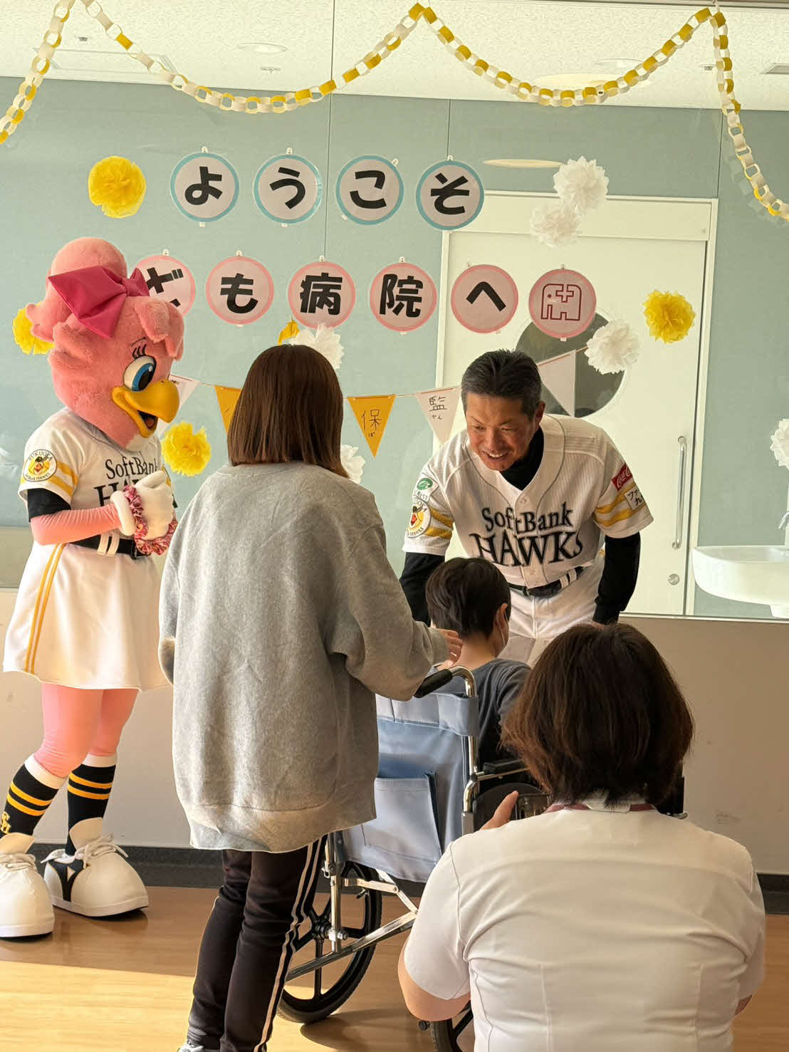 ソフトバンク小久保監督（奥）はこどもたちに記念品を手渡す。左はマスコットのハニー・ホーク