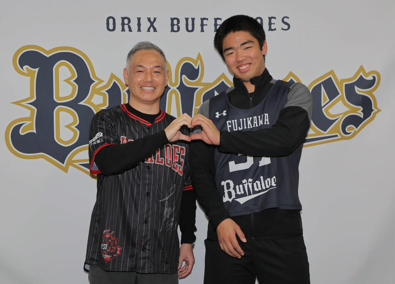 新人選手を対象に行われた「ファンサービスの大切さを伝える講習」で記念撮影のハートマーク作りを実践するオリックス藤川（右）と講師を務めた中島事業推進部副部長（撮影・宮崎幸一）