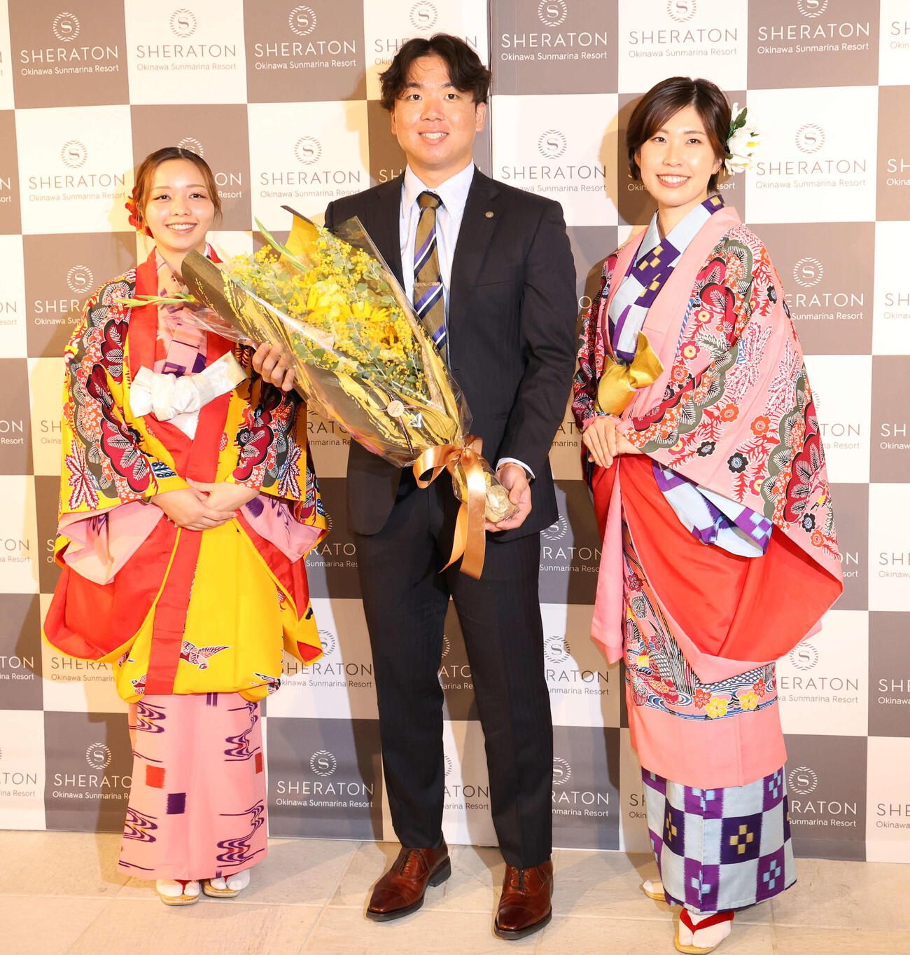 キャンプの宿舎に到着し、ホテル関係者から花束を受け取った阪神村上（撮影・西尾就之）