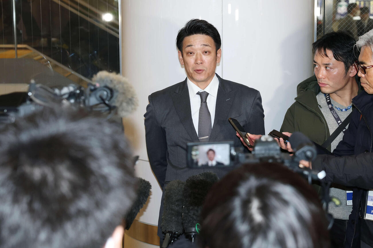 宮崎空港に到着し記者の質問に答えるロッテのサブロー監督（撮影・宮地輝）
