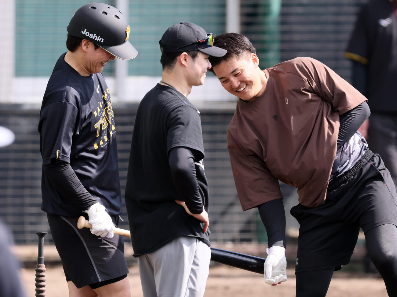 沖縄自主トレ2日目、ティー打撃練習を終えた阪神伏見（左）は通り過ぎる元山にバットを出す（撮影・加藤哉）