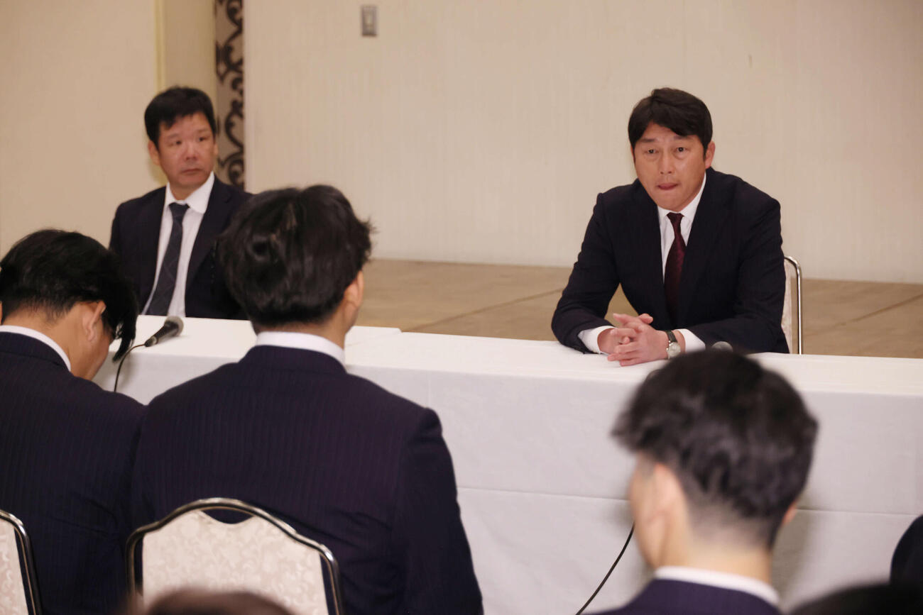 日南キャンプ入りし、全体ミーティングを行う広島新井監督（壇上右）ら。同左は藤井ヘッドコーチ（撮影・加藤孝規）