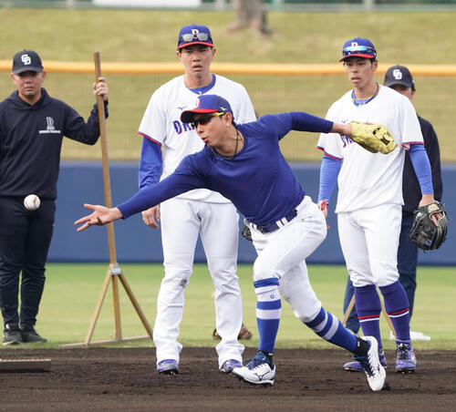 川崎臨時コーチ兼選手（中央）はノックを受ける（撮影・森本幸一）