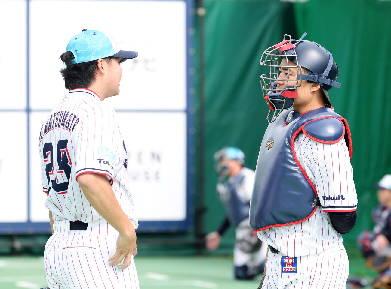 ブルペンで投球練習を終え、話すヤクルト松本健（左）と中村悠（撮影・鈴木正人）　