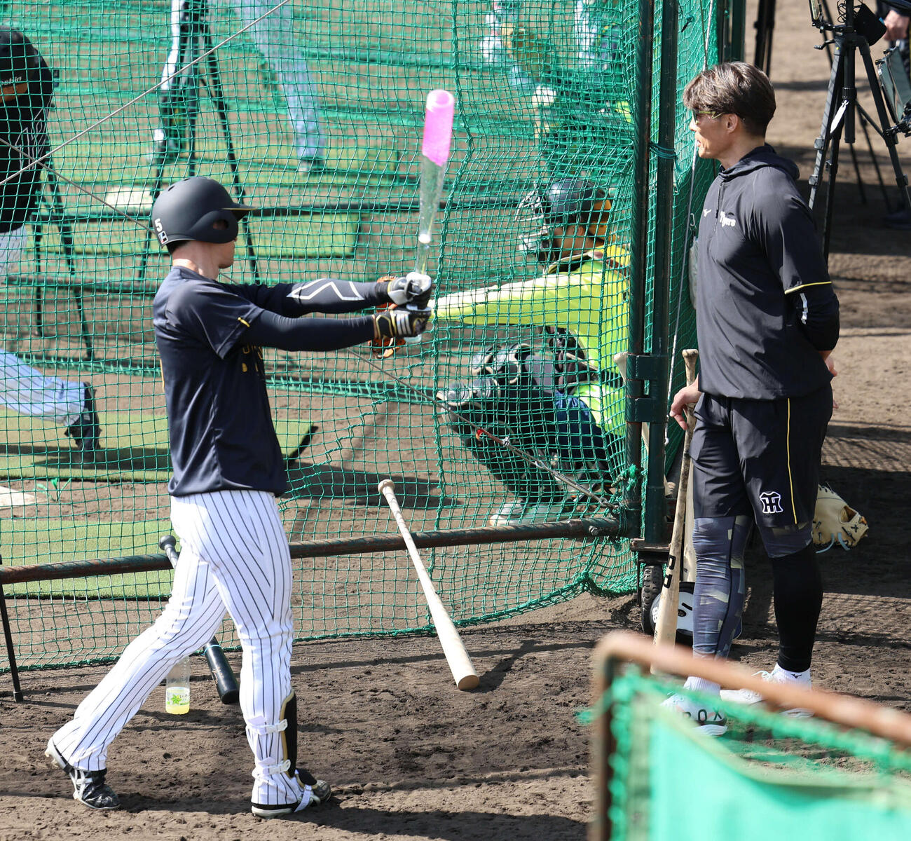 阪神糸井嘉男SA（右）が持ち込んだアクアバットを振る近本（撮影・西尾就之）