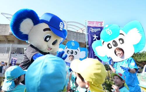 園児たちとドアラの面をつけた先生たちに囲まれるドアラ（撮影・森本幸一）