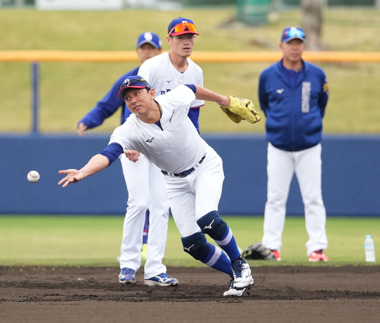 早出ノックを受ける川崎臨時コーチ兼選手（手前）右は井上監督（撮影・森本幸一）