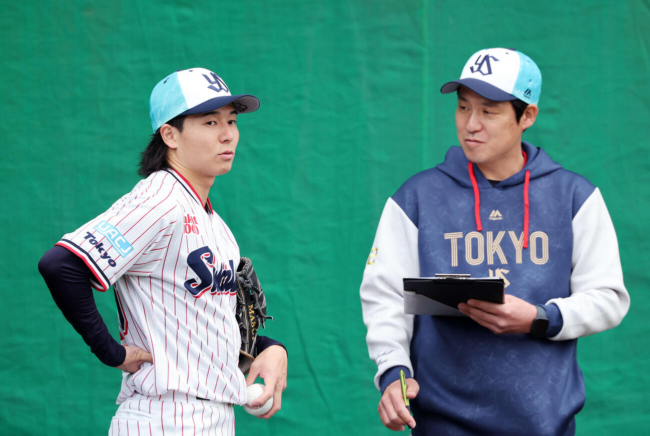 ブルペンで投球練習を終えヤクルト山本投手コーチ（右）と話す増居（撮影・鈴木正人）　