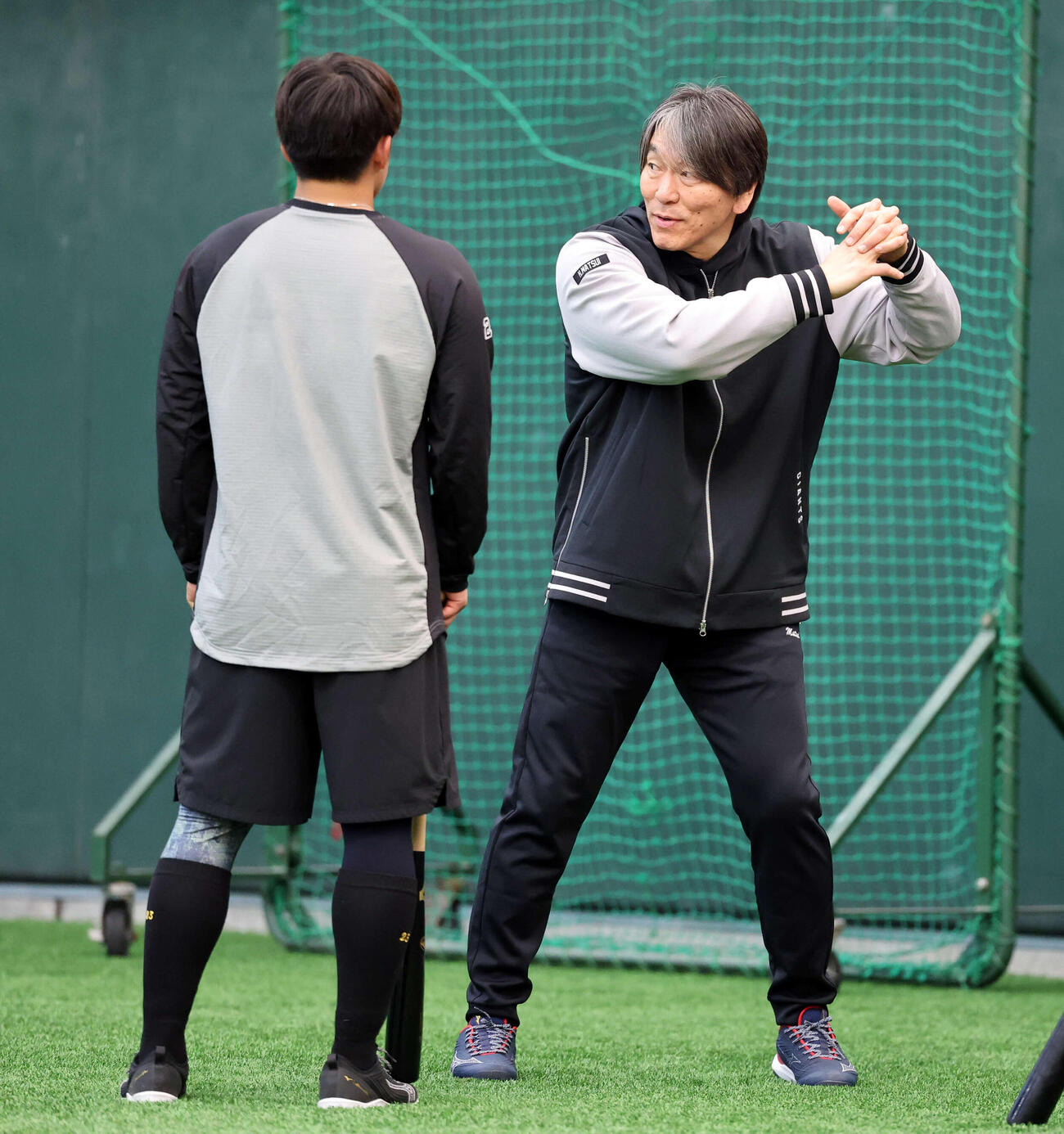 巨人石塚（左）を身ぶり手ぶりで指導する松井臨時コーチ（撮影・浅見桂子）