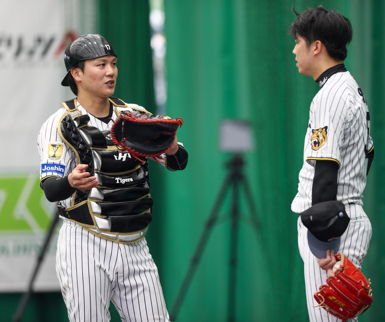 ブルペンで投球を終えた阪神才木（右）と話す伏見（撮影・上山淳一）