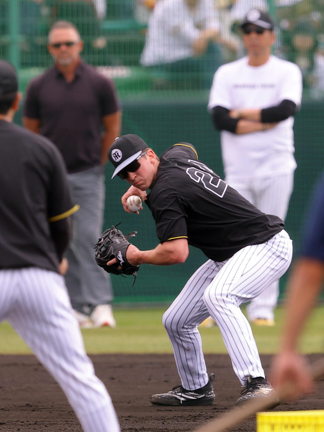 阪神ウィリアムス駐米スカウト（左）と藤川監督（右）が見守る中ノックを受けるディベイニー（撮影・上田博志）