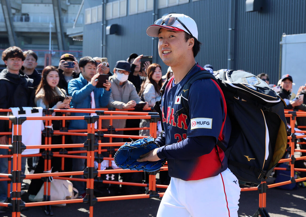 ファンの前を通ってサブグラウンドへ移動する侍ジャパンサポートメンバーの佐藤柳（撮影・加藤哉）
