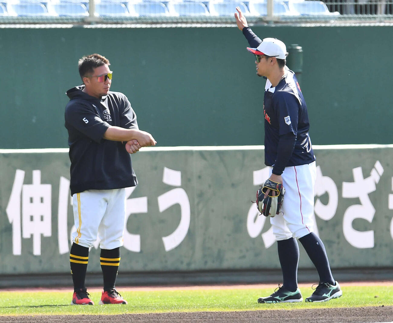 日本対ソフトバンク　試合前、ソフトバンク山川（左）と打撃の話をする侍ジャパン佐藤（撮影・岩下翔太）