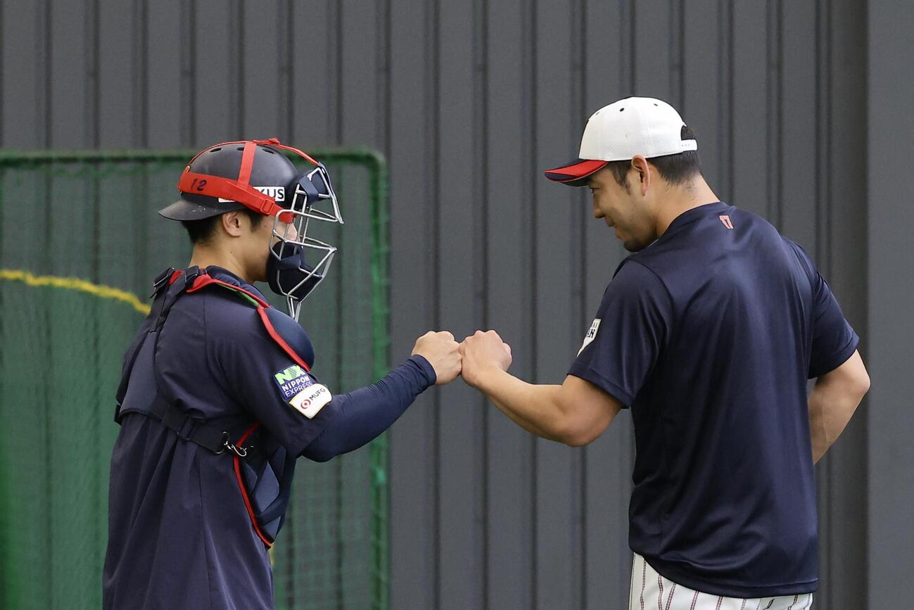 ブルペンでグータッチを交わす坂本（左）と菊池（撮影・河田真司）