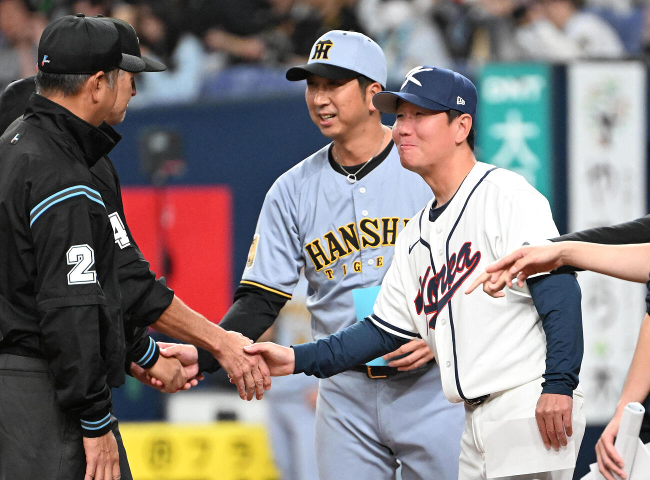 阪神対韓国　メンバー表を交換し審判と握手する阪神藤川監督（右から2人目）、韓国代表柳志炫監督（右）（撮影・石井愛子）