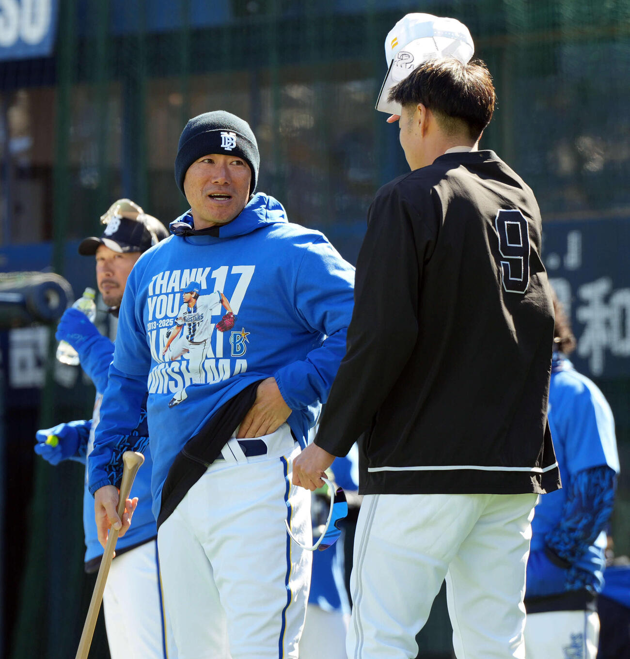 DeNA対ソフトバンク　三嶋一輝のティーシャツを着て練習を見るDeNA相川監督。右はソフトバンク柳田（撮影・たえ見朱実）