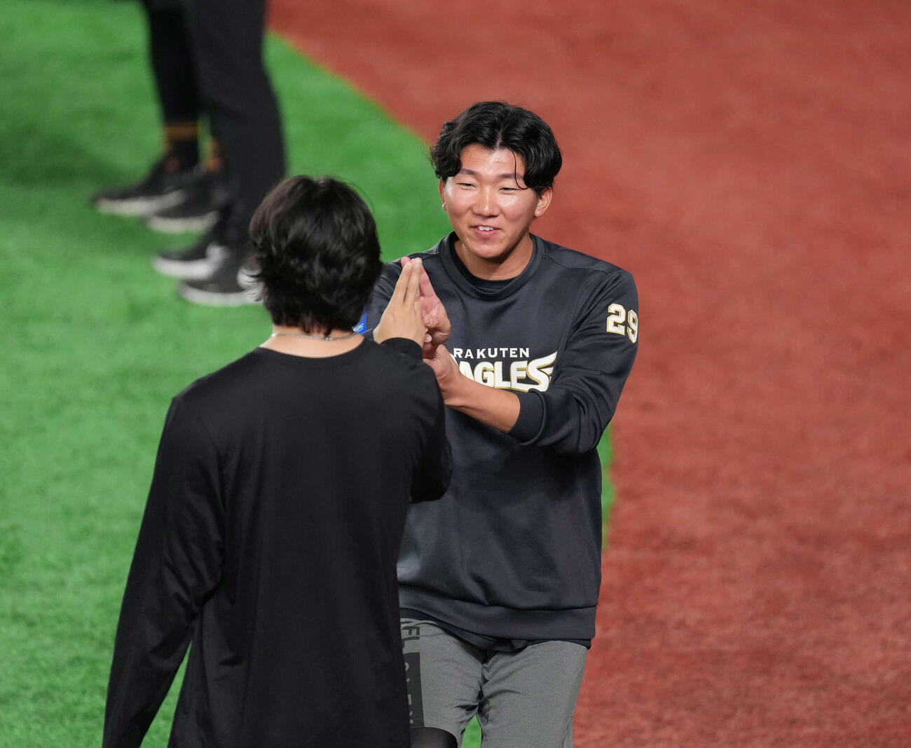 試合前、巨人田中瑛（手前）とタッチを交わす楽天田中千（撮影・増田悦実）