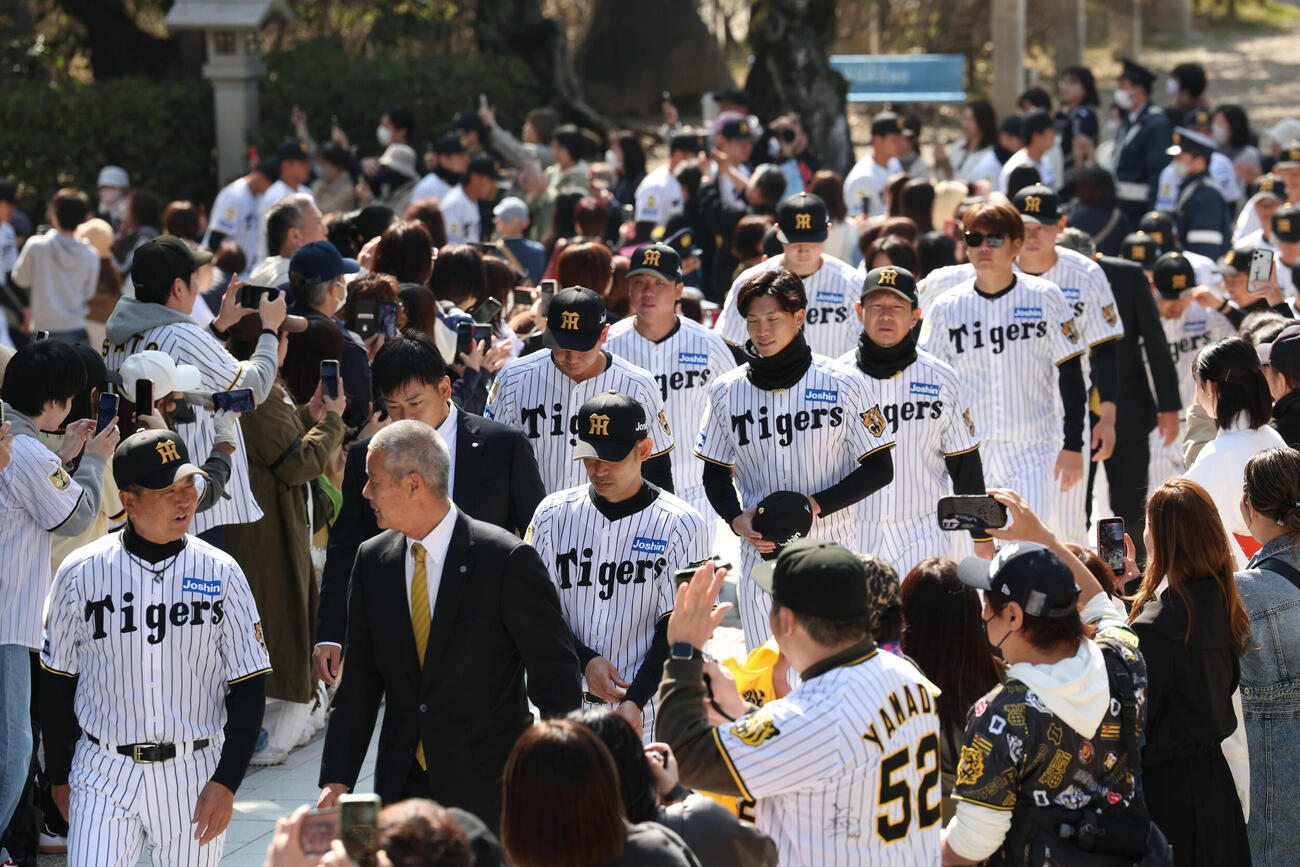 大勢のファンが見守る前、必勝祈願に参加した及川（右手前）ら阪神ナイン（撮影・西尾就之）