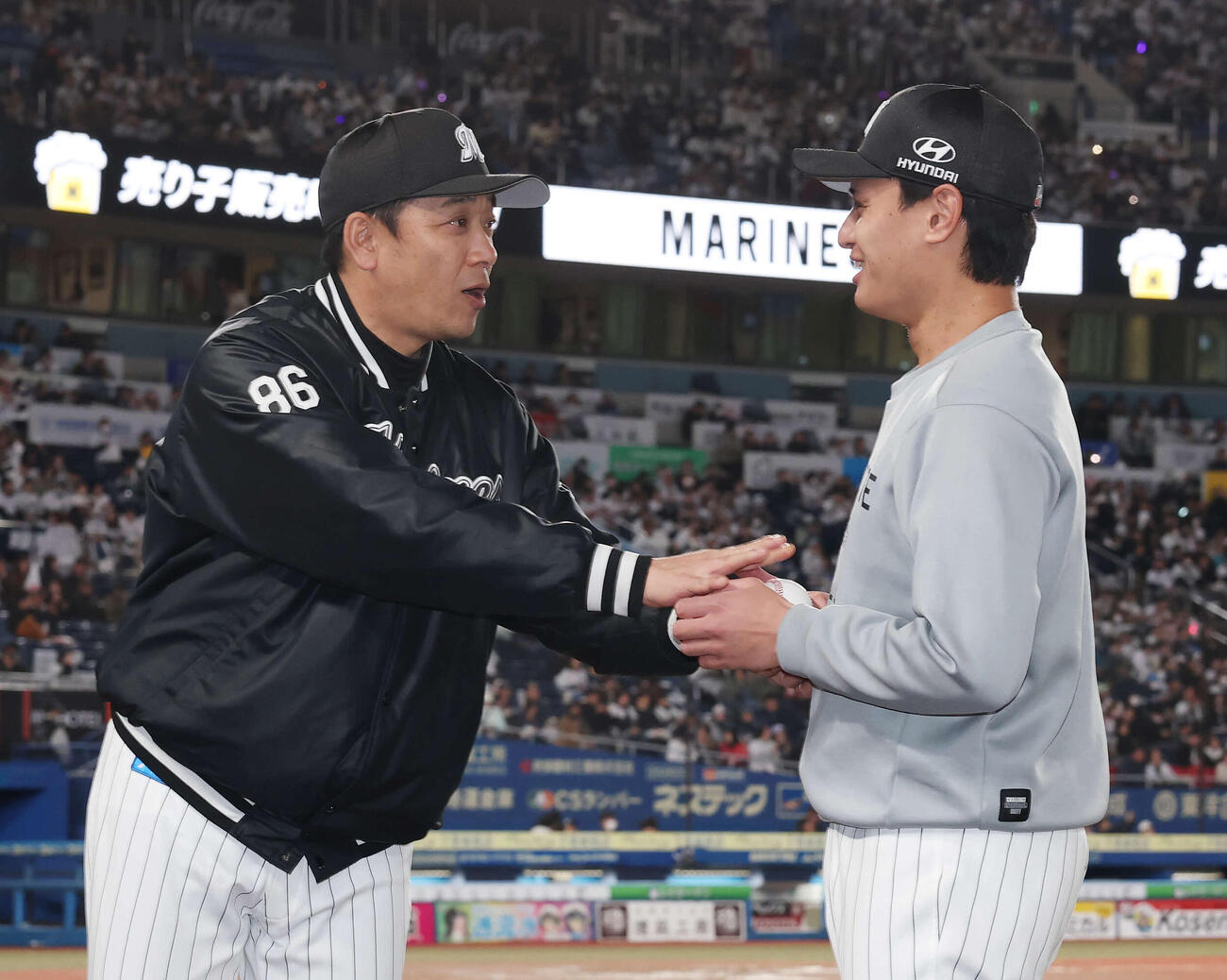 ロッテ対西武　初勝利を挙げロッテのサブロー監督（左）からウイニングボールを受け取る毛利（撮影・宮地輝）