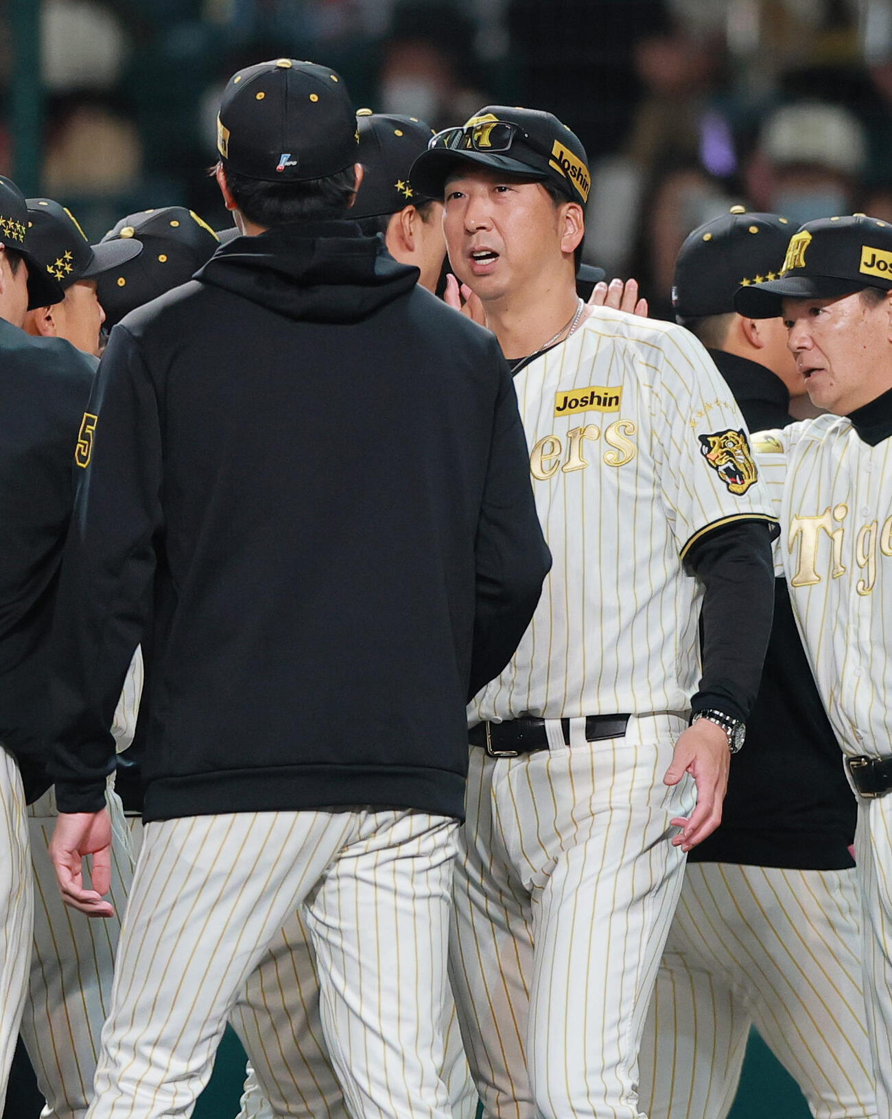 阪神対ヤクルト　ヤクルトに勝利し、セ・リーグタイ記録の16奪三振をマークした阪神才木（手前）とタッチをかわす藤川監督（撮影・上山淳一）