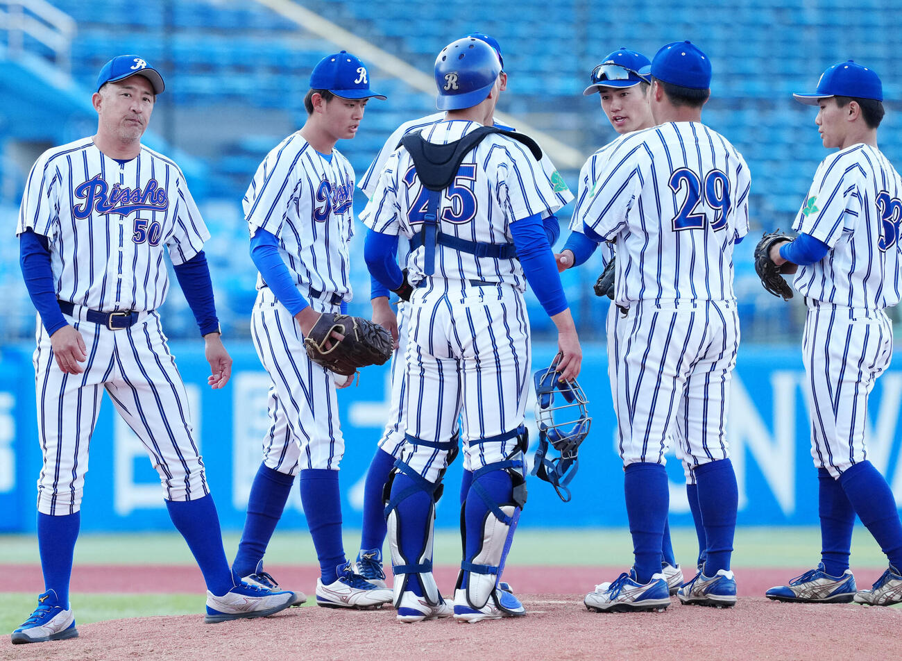 立正大対東洋大　4回裏、選手たちに指示を出した立正大・金剛監督（左端）（撮影・江口和貴）