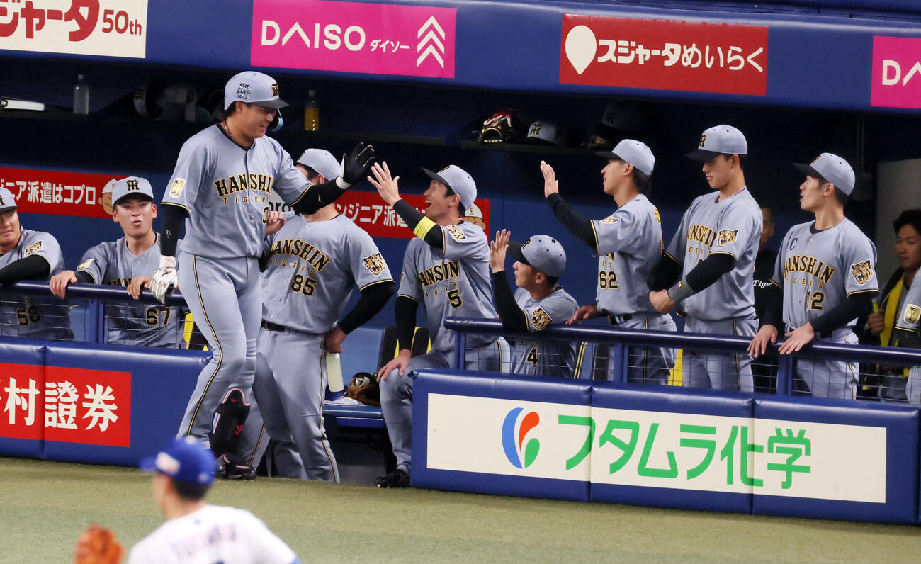 中日対阪神　2回表阪神無死、ソロ本塁打を放った大山はベンチのナインとタッチする（撮影・加藤哉）