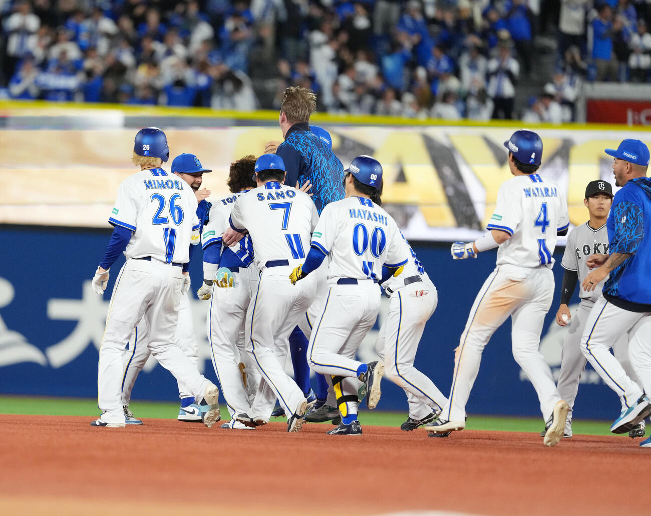DeNA対巨人　11回裏1死一、二塁、サヨナラの適時二塁打を放った戸柱恭孝に駆け寄るDeNAナイン（撮影・増田悦実）